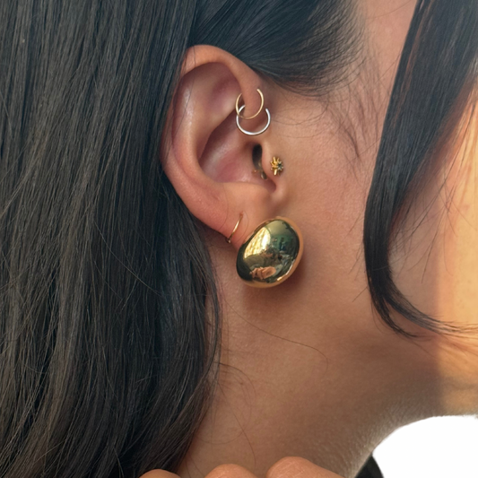 model's ear showcasing a gold filled half dome chunky earring