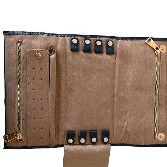 Inside of a leather travel case with earring holders, ring holders, zippers and other storage for jewelry