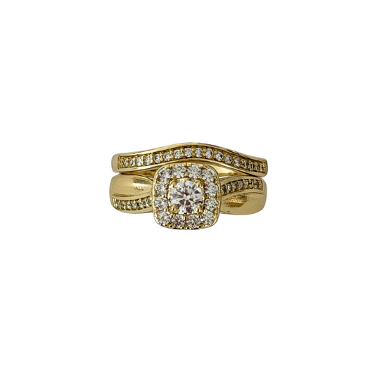 A yellow gold wedding band featuring a central cushion-cut diamond surrounded by a halo, with two curved bands behind it, both adorned with small pavé-set diamonds, shown on a plain white background.