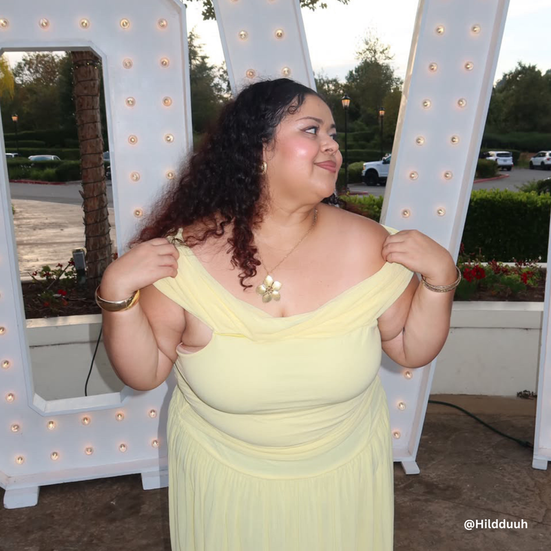Hilda Franco in a pastel yellow wedding guest dress and a statement Flor necklace from siempre chula jewelry