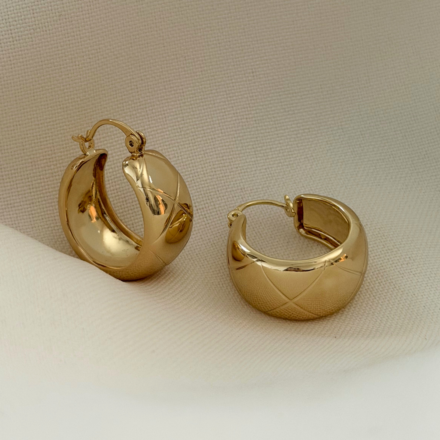 Gold hoop earrings with quilted details
