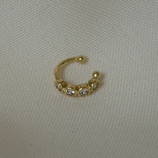 an ear cuff with round bezel cubic zirconia stones