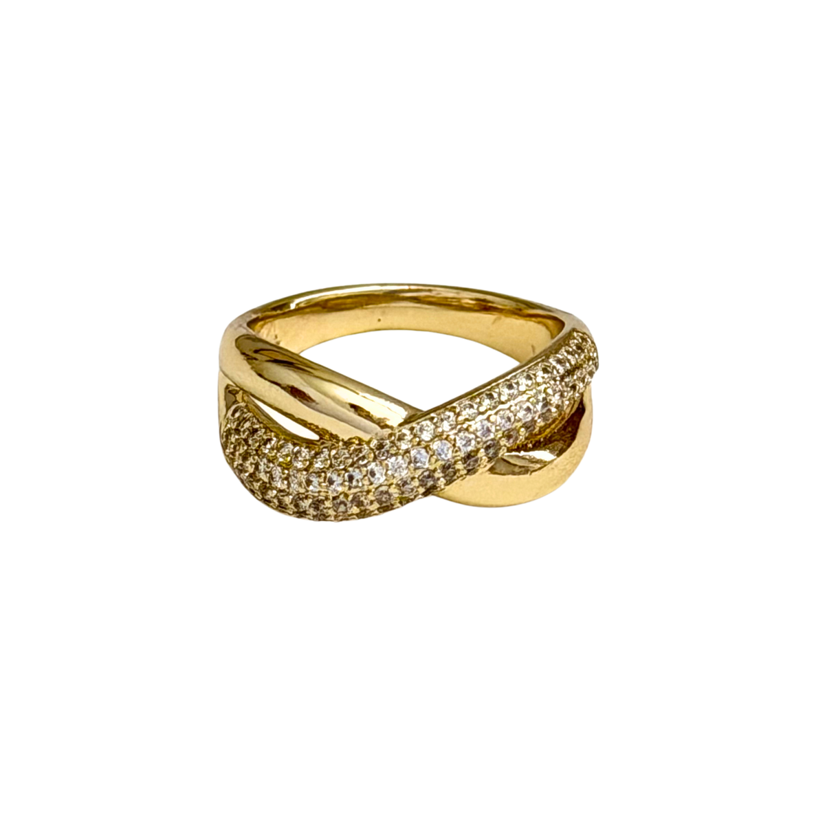 A gold ring with a twisted, intertwined band design, featuring one half paved with small clear stones and the other half polished gold, shown on a plain white background.